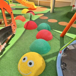 Vibrant blue wet-pour safety flooring newly installed in an outdoor playground