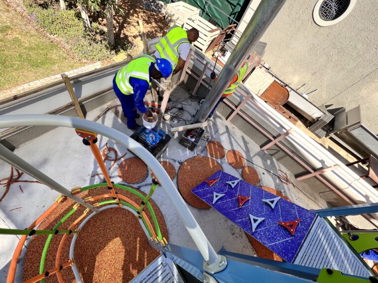 Expert installers meticulously applying wet pour rubber playground surfacing to ensure quality, safety, and durability.